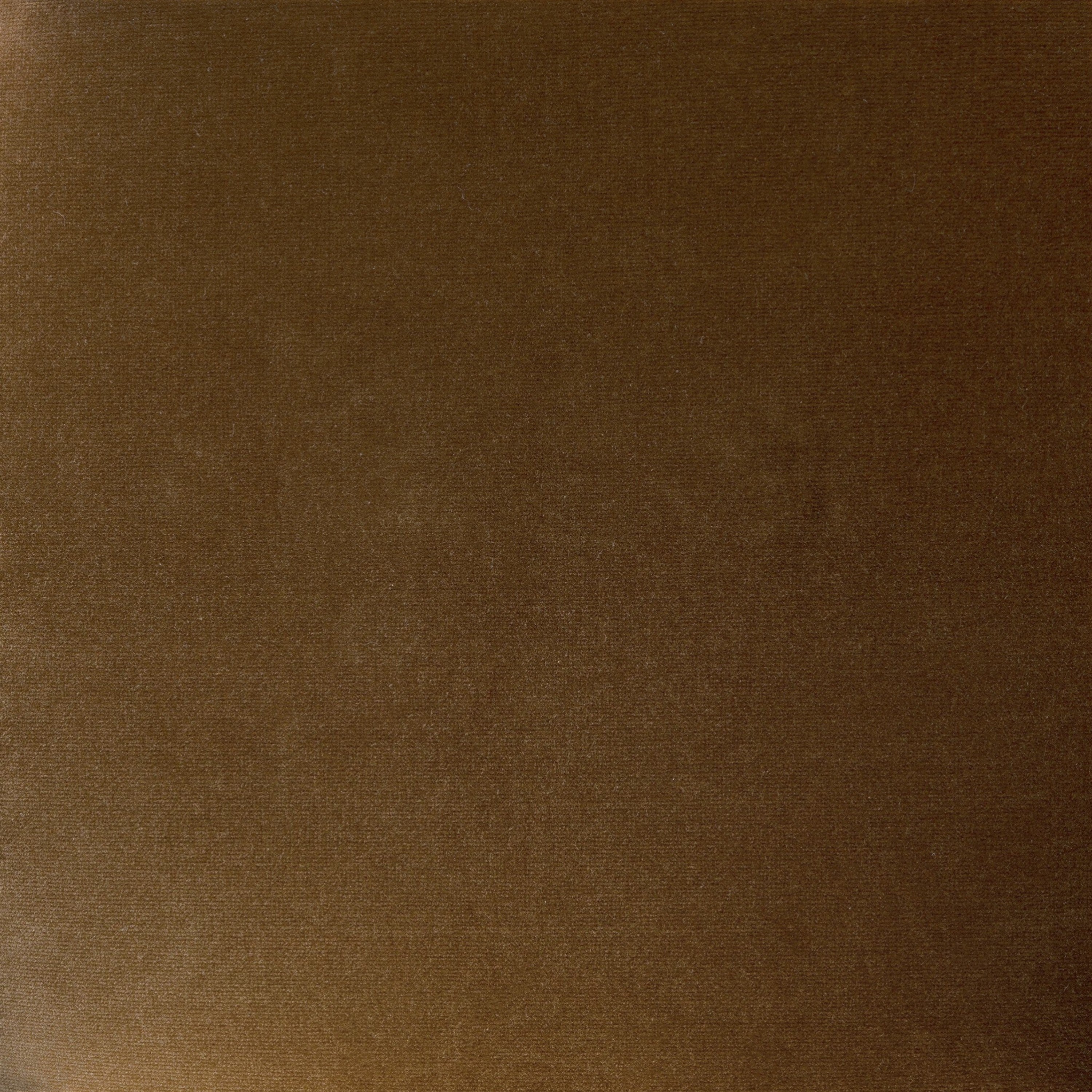 Close-up of Surrey Ochre velvet upholstery in a warm golden brown tone.