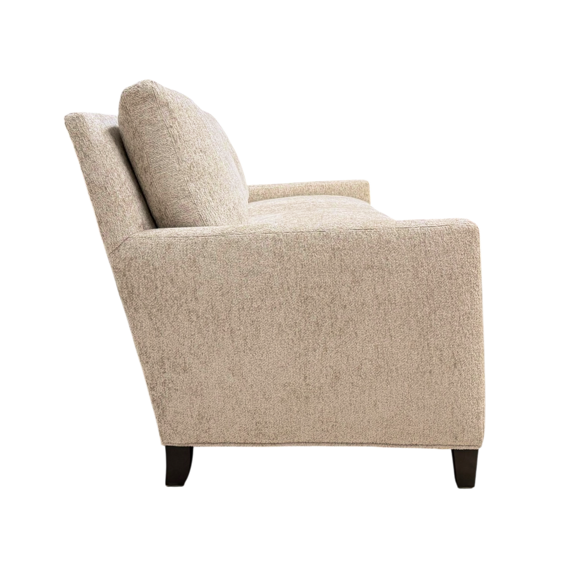 Weston Sofa side view highlighting the low-profile frame, gently reclined back panel and slim track arm in warm Foundry Sand chenille.