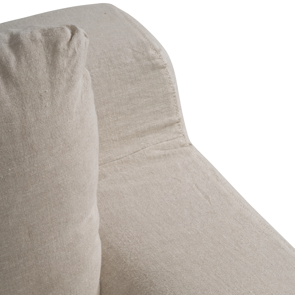 Babylon Sofa close-up of the natural linen slipcover, showing the back cushion, stitched seams and the gently angled arm.