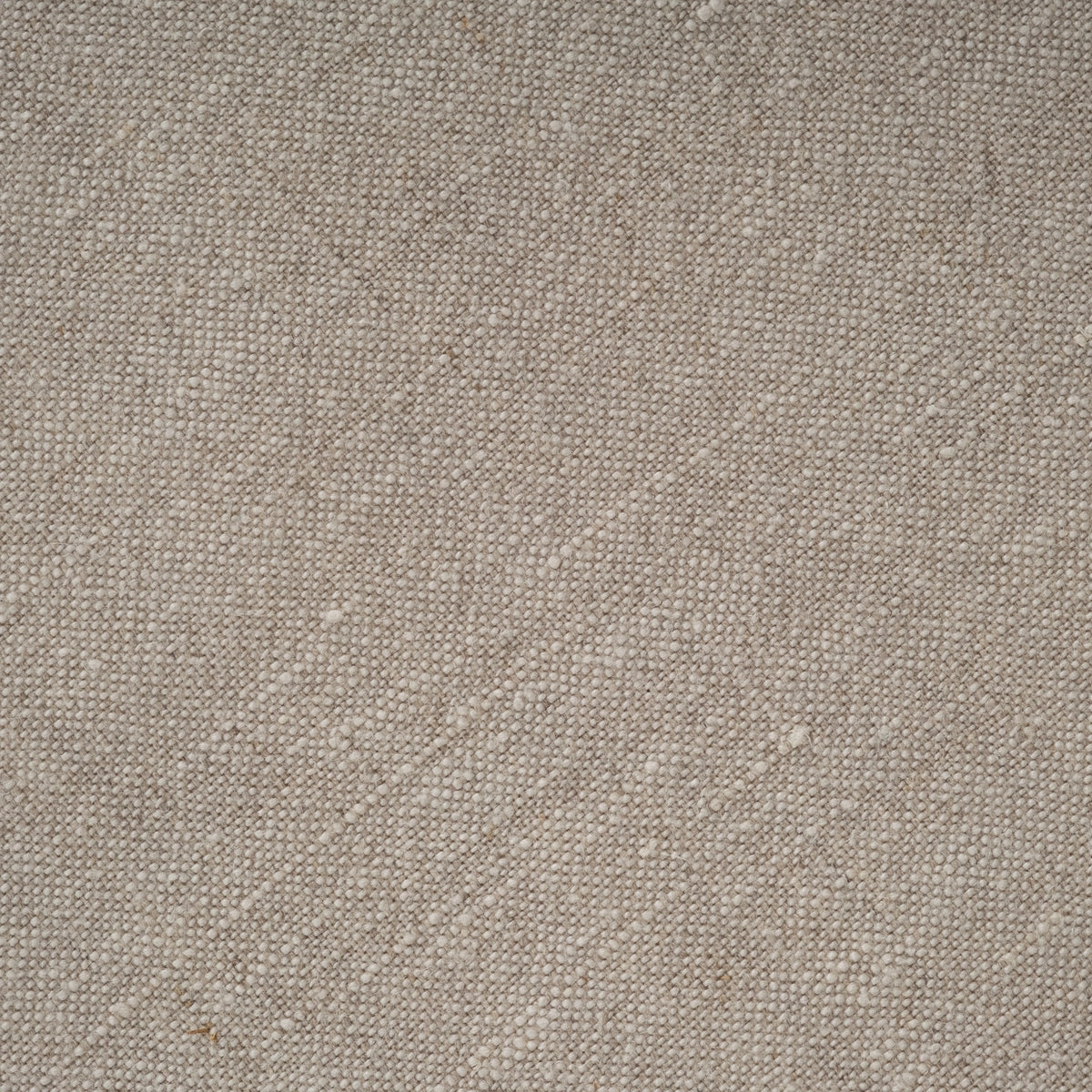 Close-up of the natural linen fabric on the Babylon Sofa, with a slubby, loose weave in warm oatmeal tones.