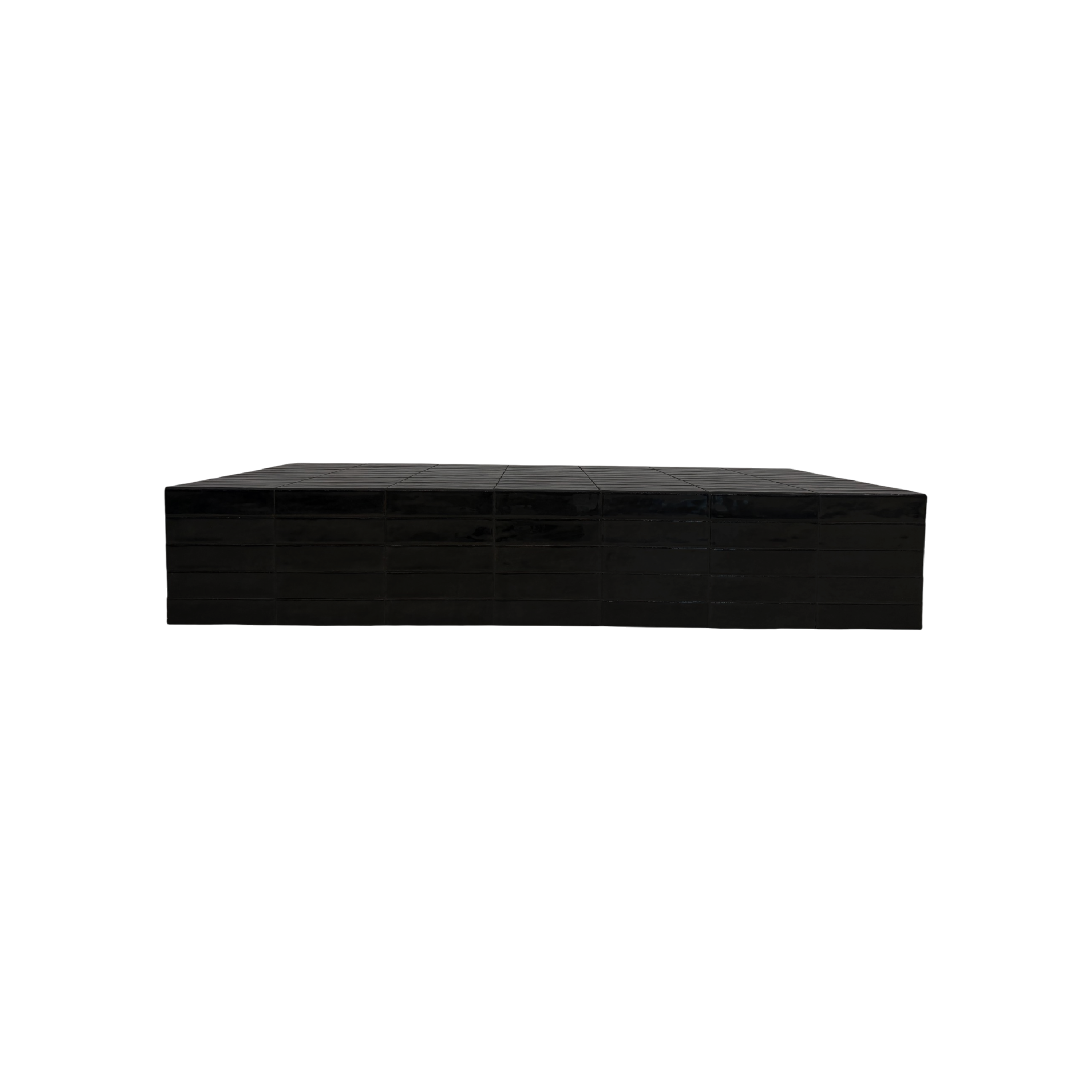 Bloom Coffee table is a glossy black rectangular display stand or riser, photographed from a low angle against a solid white background.