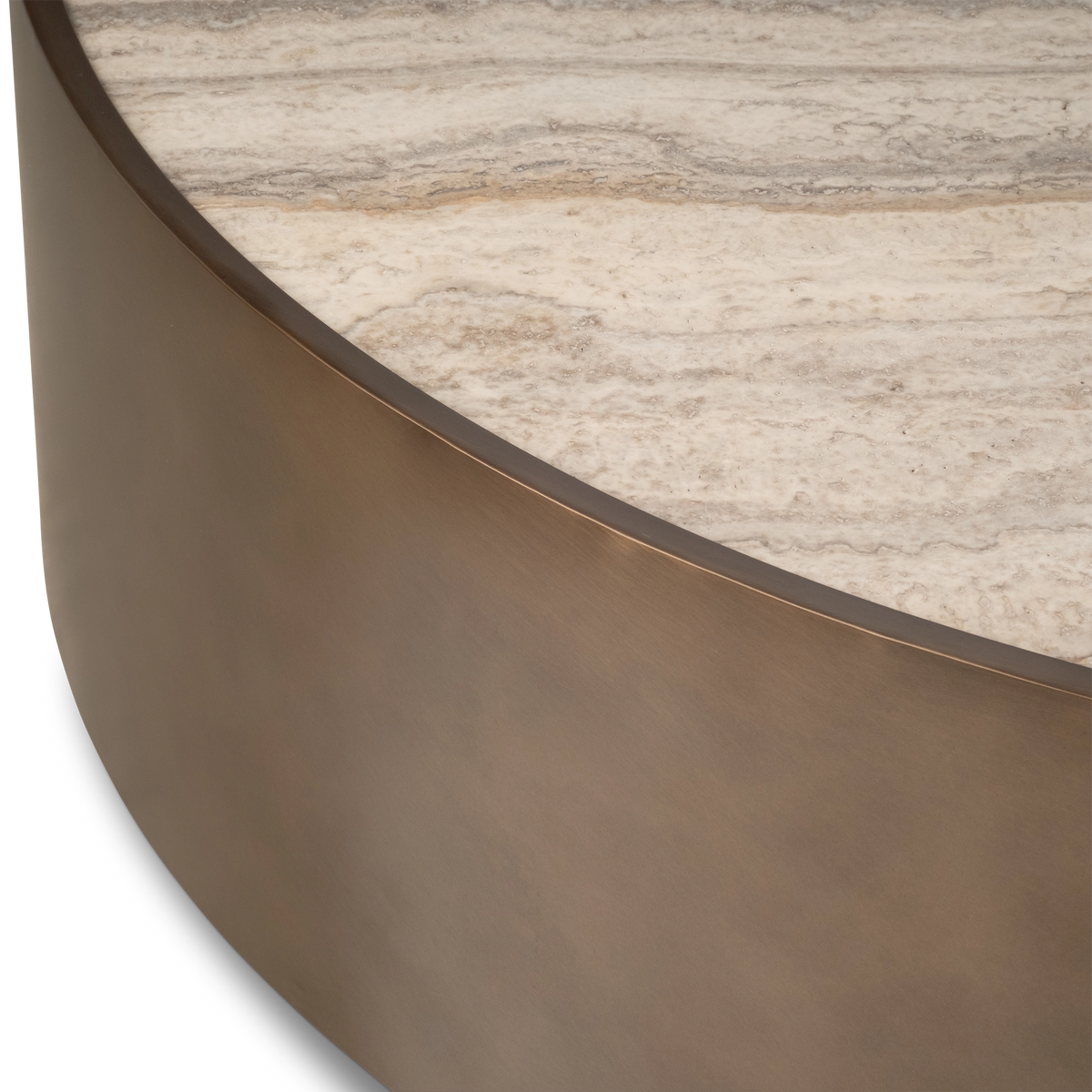Close-up showing the Pedra Round Coffee Table’s curved Aged Bronze metal side meeting the cream travertine top, with layered taupe and tan veining.
