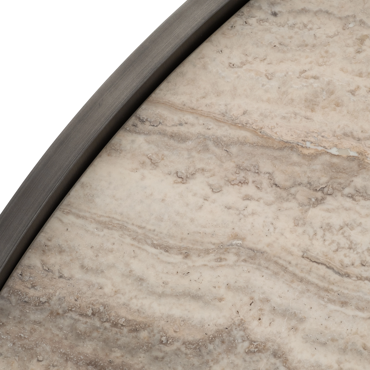 Close-up showing the Beam Coffee Table’s cream travertine top with taupe and tan veining and natural pitting, framed by a curved Aged Pewter metal rim.