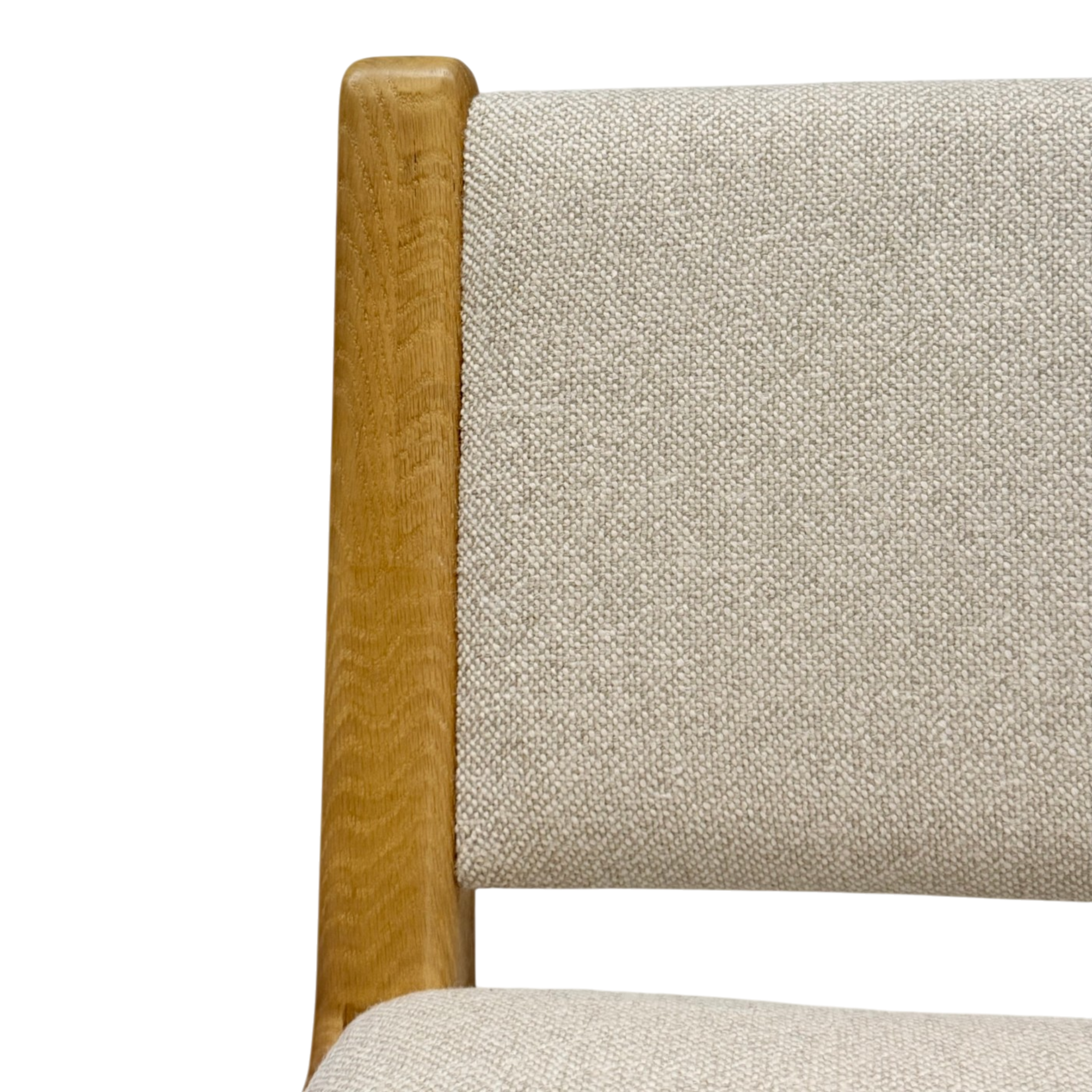 Close-up detail of a chair showing a light beige textured fabric upholstery and a natural oak wood frame on a white background.