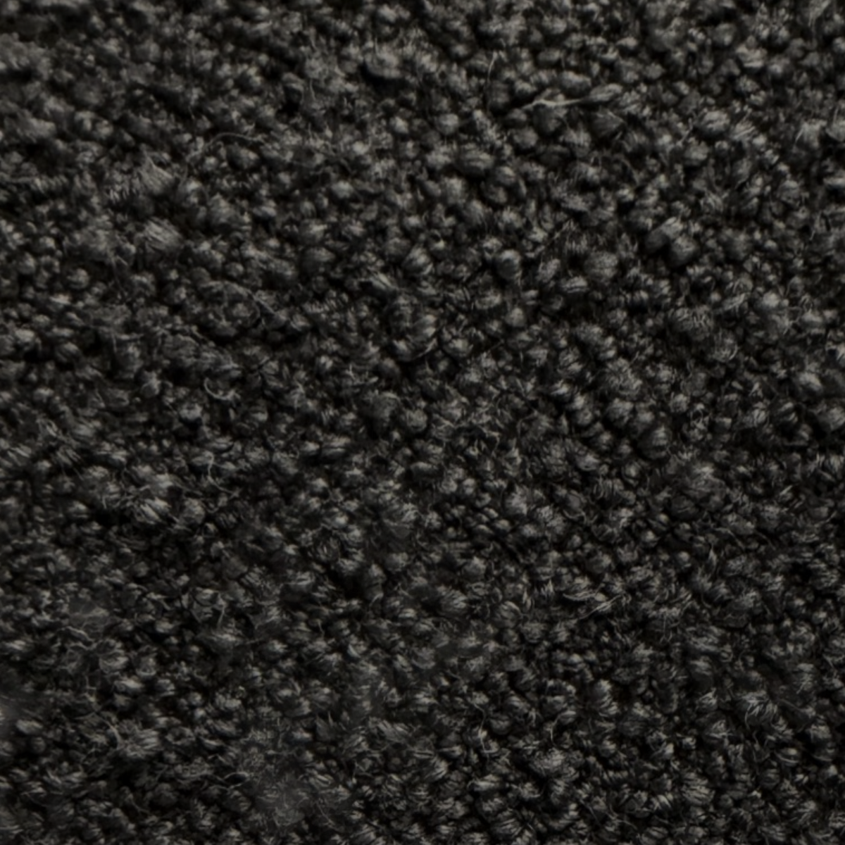 Detail view of the Arcus Swivel Chair upholstery showing the deep charcoal boucle-like textured fabric.