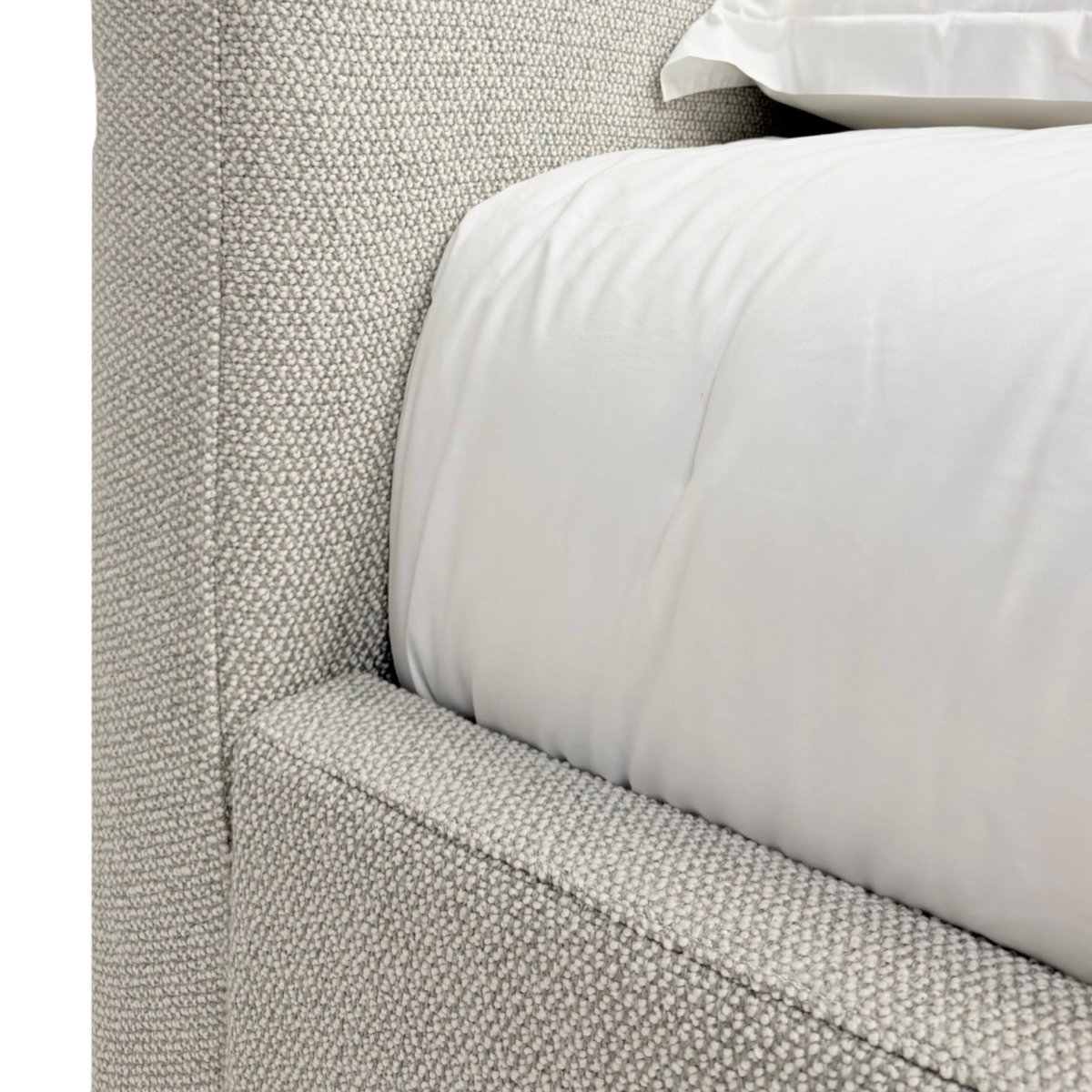 Close-up of the Vital King Bench Footboard Bed showing white bedding framed by the upholstered headboard and low-profile side rail.
