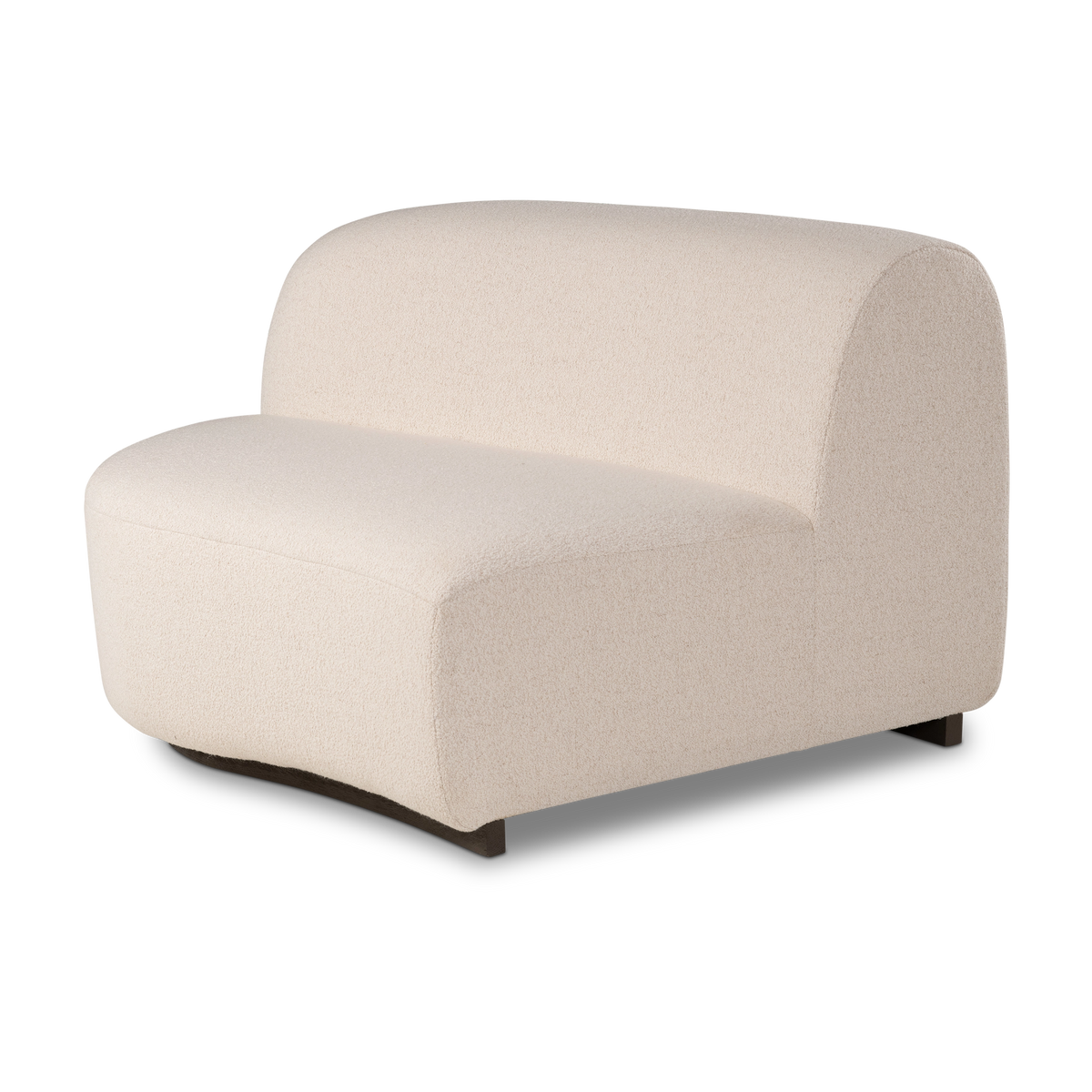 Angled view of the Rhine Modular LAF Chair in cream bouclé, showing the arched back, the smooth curved seat front, and the dark block feet beneath.