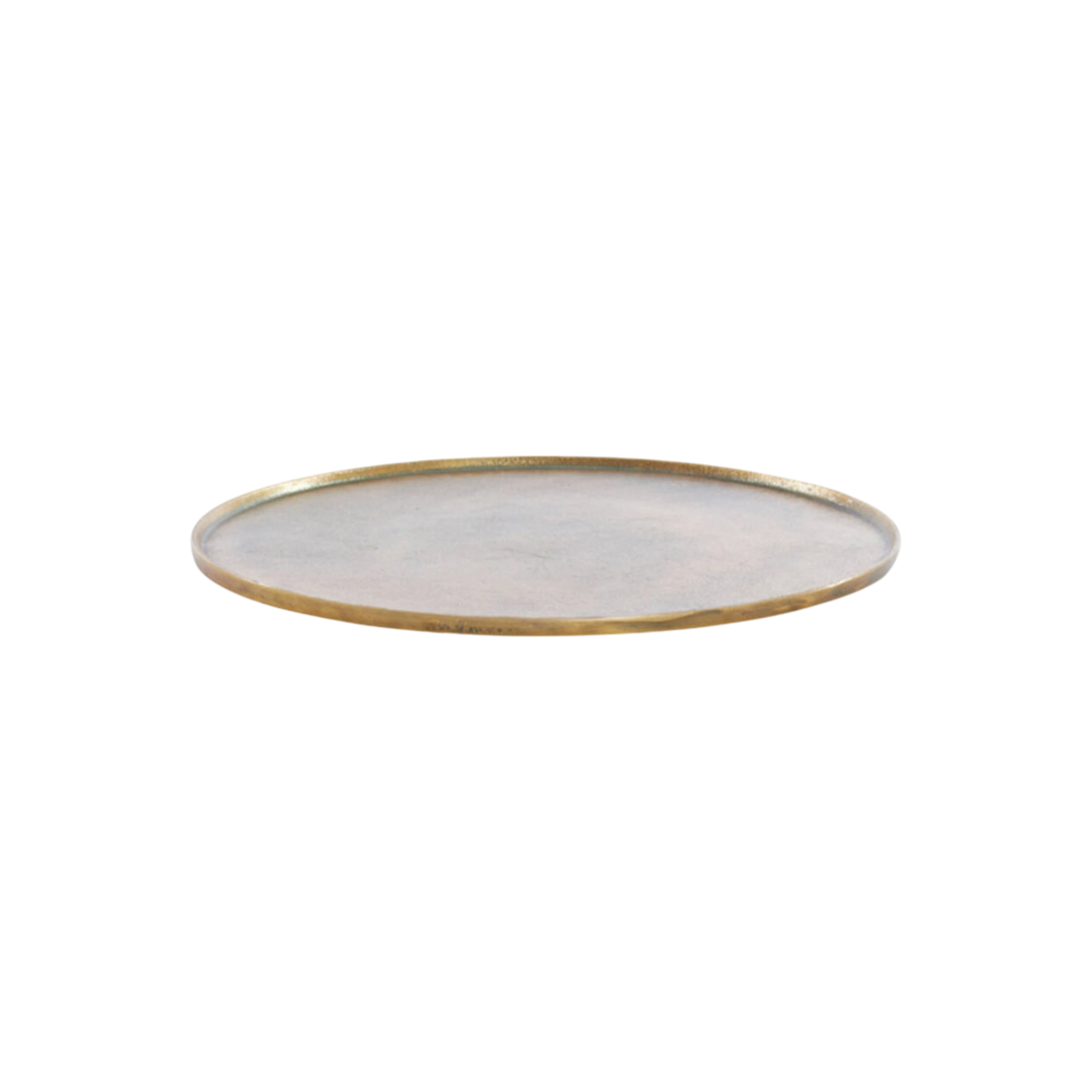 Russell Tray Round Medium in antiqued brass, shown from a low side angle, with a slim raised rim, a mottled brushed metal surface, and a worn gold edge.