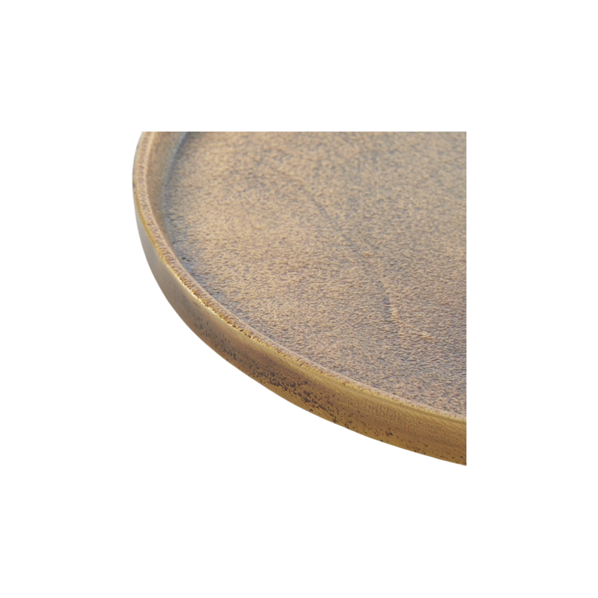 Close-up showing the rim of the Russell Tray Round Large in antiqued brass, with a thin raised lip, a sand-like cast texture, and dark oxidized speckling along the outer edge.
