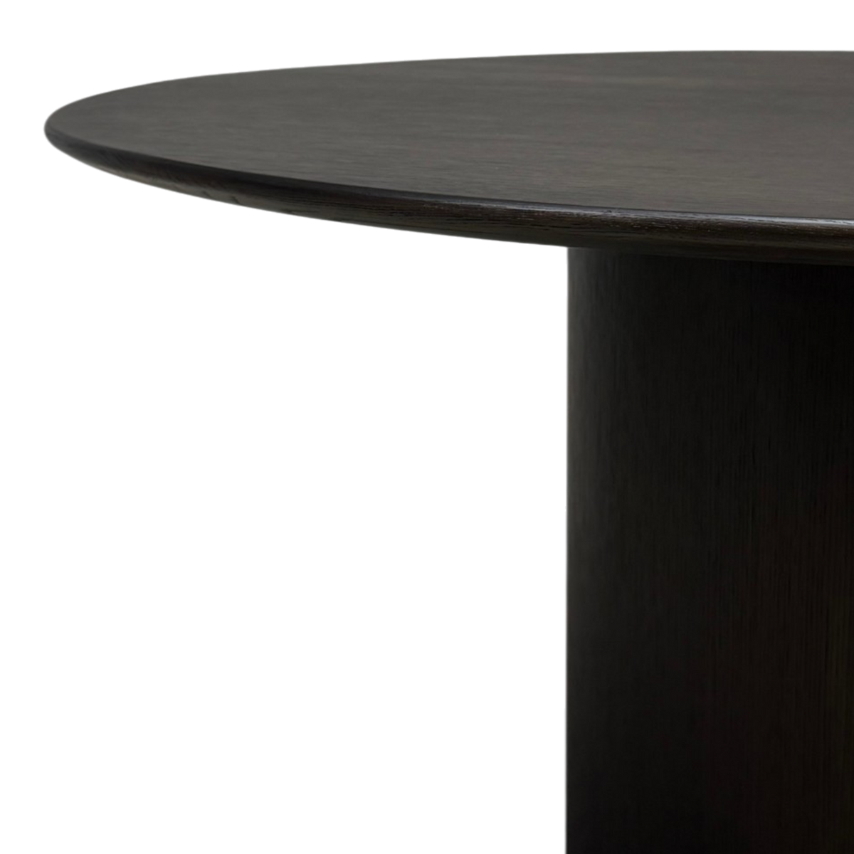 Close-up of Altar Round Dining Table showing softly rounded tabletop edge and dark brown oak pedestal.