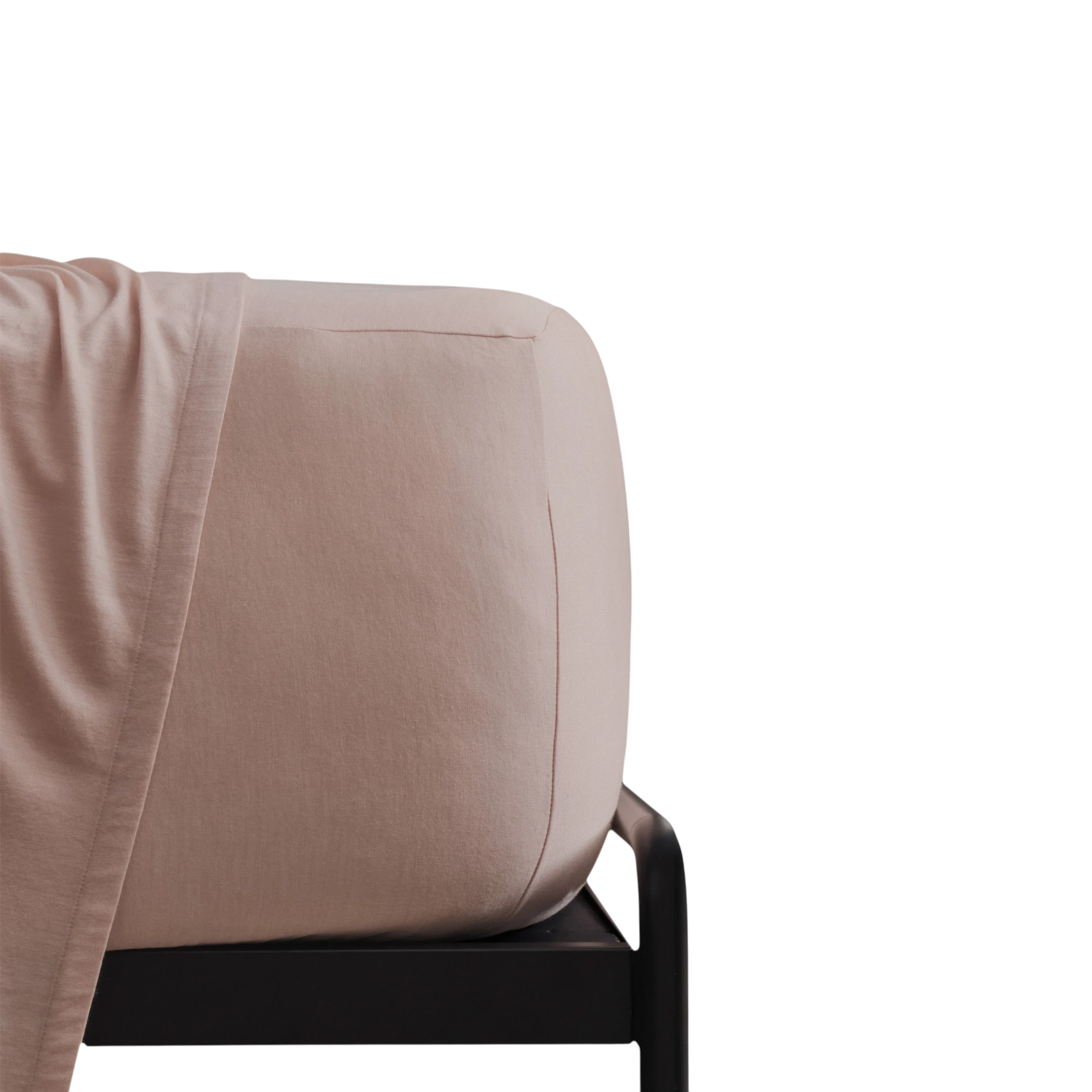 Merino Fit Sheet King in Rose Merino Jersey shown fitted over a mattress with coordinating bedding draped over the edge.