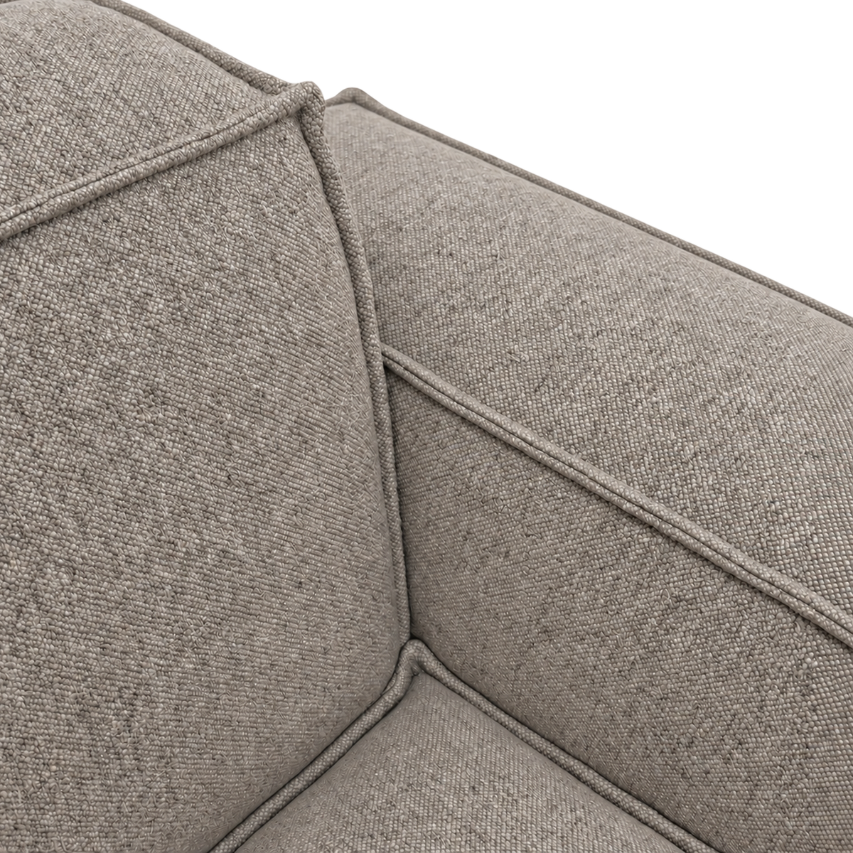 Vetro Modular Sectional Sofa close-up showing the nubby heathered taupe weave, with piped seams where the cushions meet and lighter and darker yarns flecked throughout.