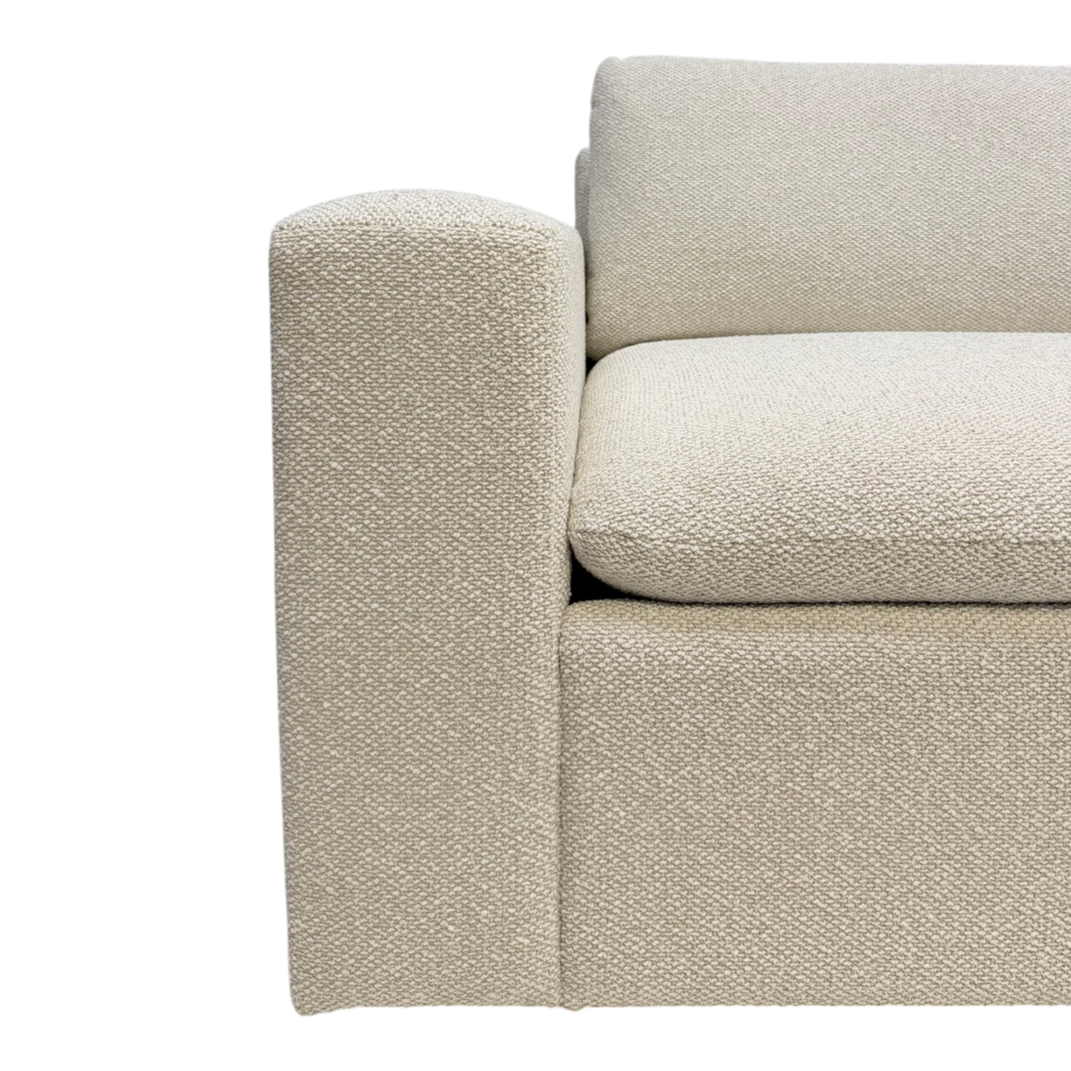 Tempo Modular Sectional close-up showing textured ivory upholstery across the arm, loose seat cushion, and back cushion with a soft woven finish.