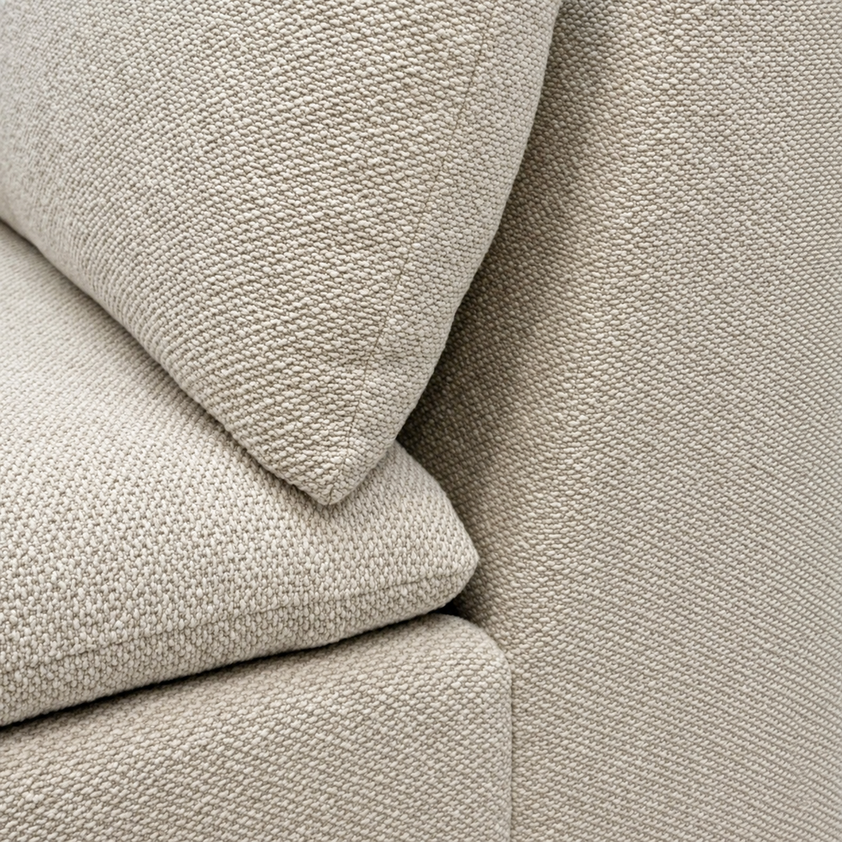 Tempo Modular Sectional close-up showing the soft, flecked heathered greige weave across a loose back cushion, plump seat cushion and boxed base.