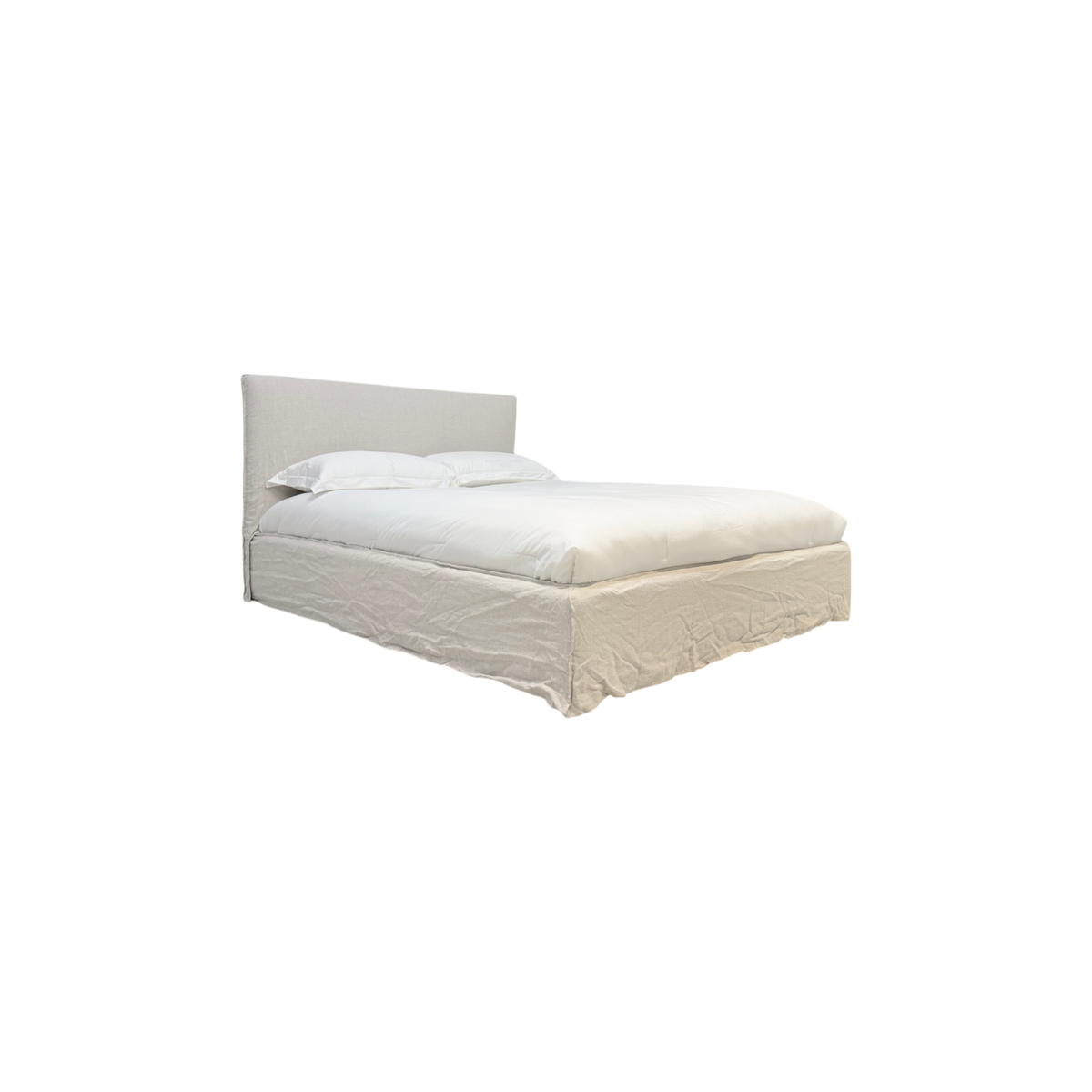 Muse Queen Bed in natural linen, three-quarter view highlighting the upholstered headboard, soft white bedding, and loosely draped linen bed skirt.