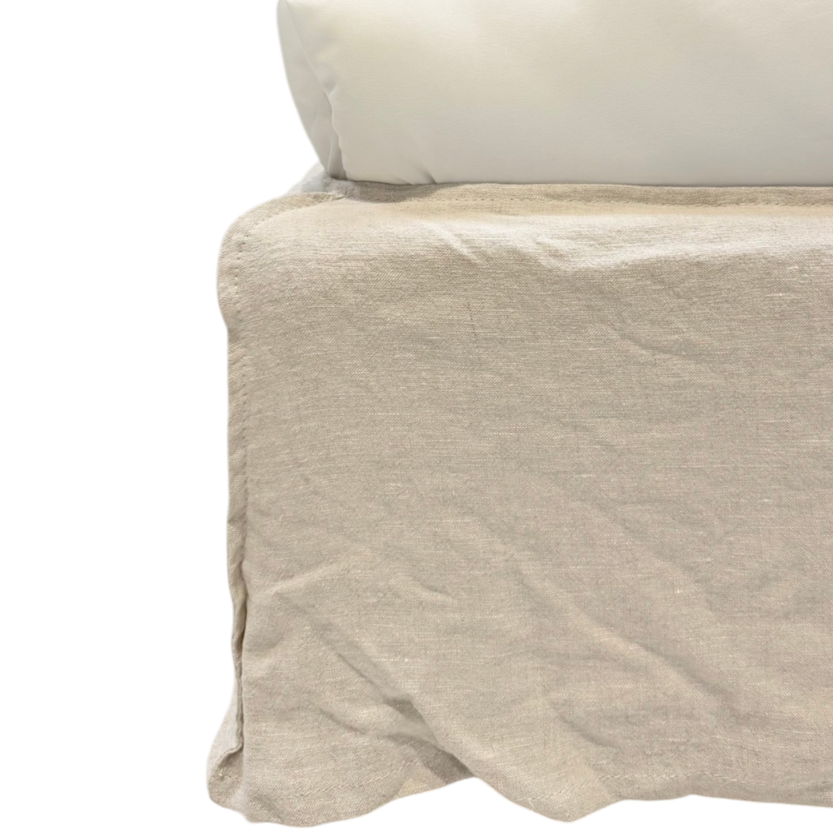 Close-up of the Muse Queen Bed showing the natural linen slipcover skirt with its soft texture, relaxed folds, and gently pooled hem.