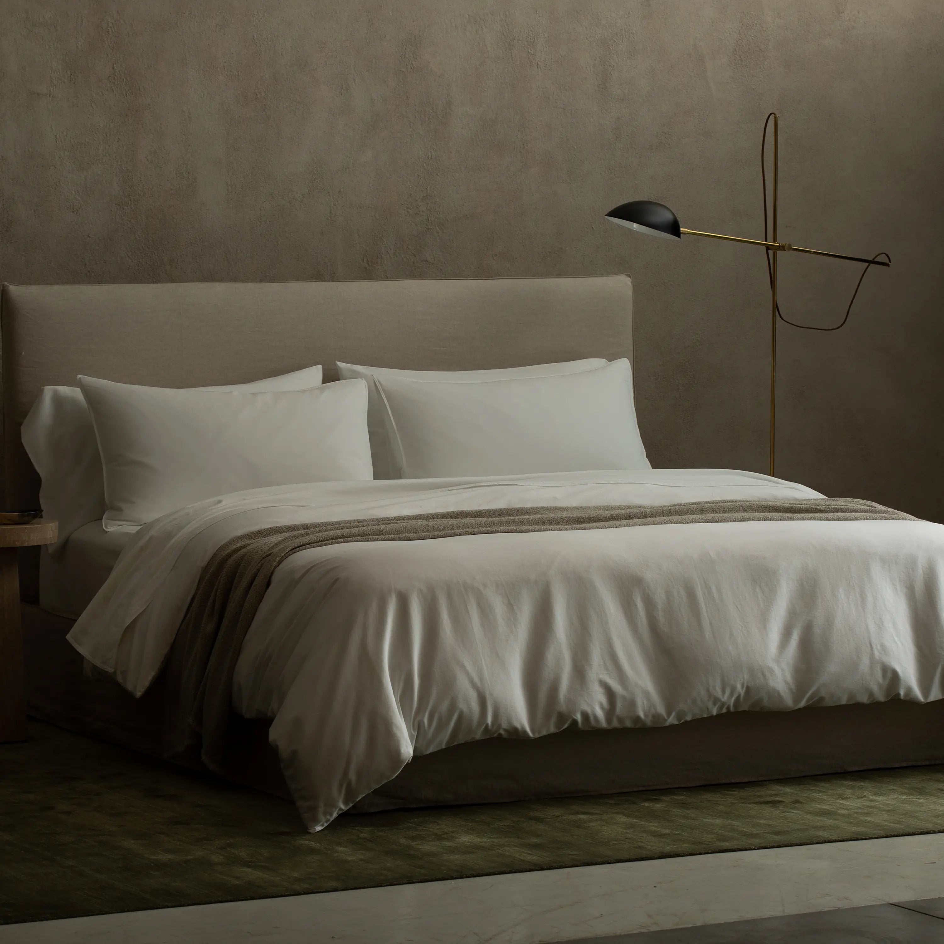 A minimalist floor lamp with an adjustable arm and exposed wire for a contemporary feel.