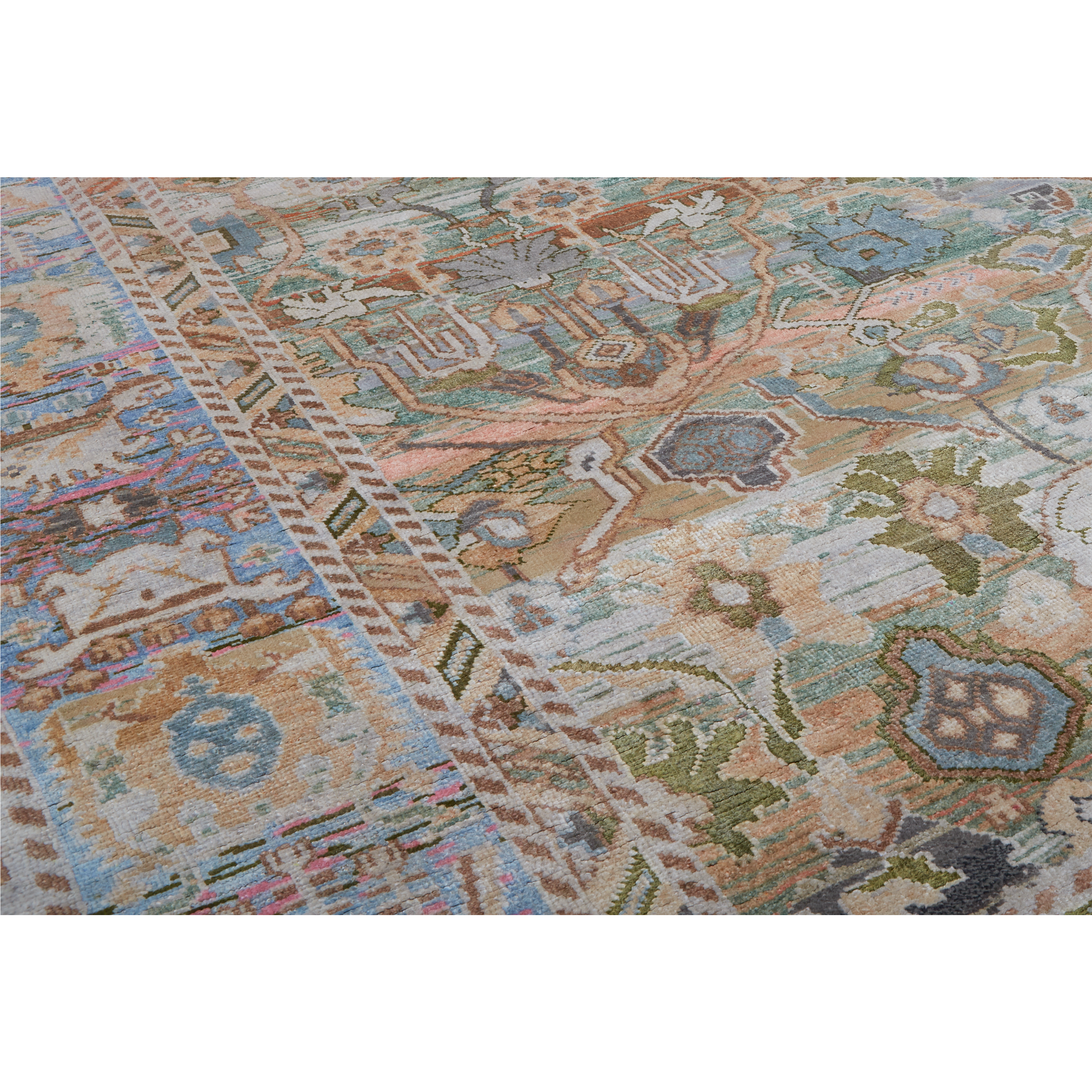 A close-up of a traditional patterned area rug with a complex geometric and floral design in muted tones of beige, blue, green, and brown.