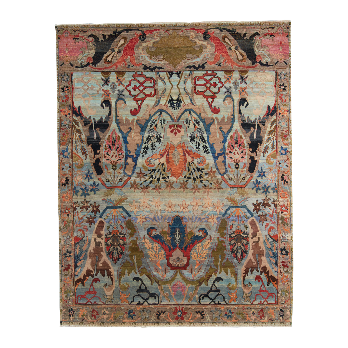 An ornate rectangular area rug with a complex symmetrical floral and botanical pattern, featuring a central field of light blue and beige with red, orange, and green motifs, surrounded by a patterned border.