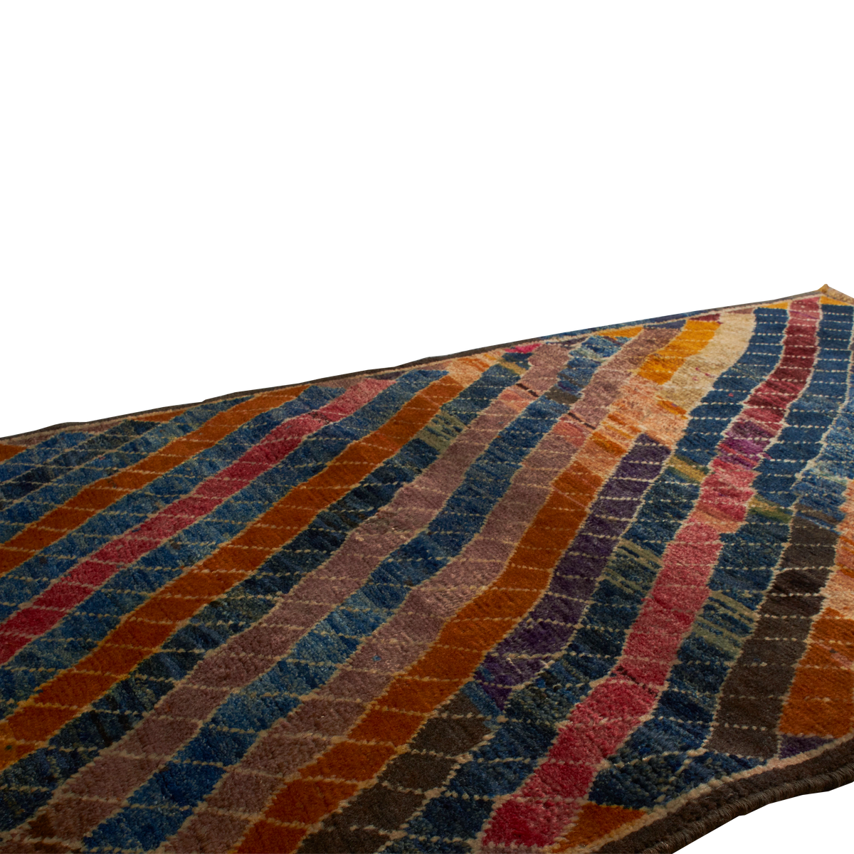 A close-up of a textured area rug with a multicolor striped pattern of wavy diagonal bands in blue, orange, red, purple, and brown.