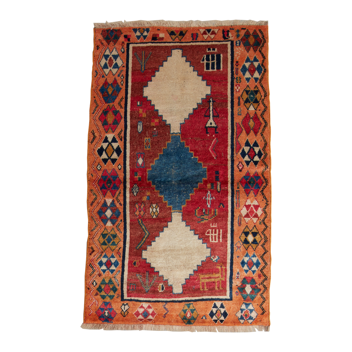 A rectangular hand-woven rug with a traditional geometric pattern, featuring a red central field, a blue diamond motif, cream-colored diamond shapes, and an orange border with intricate geometric details.