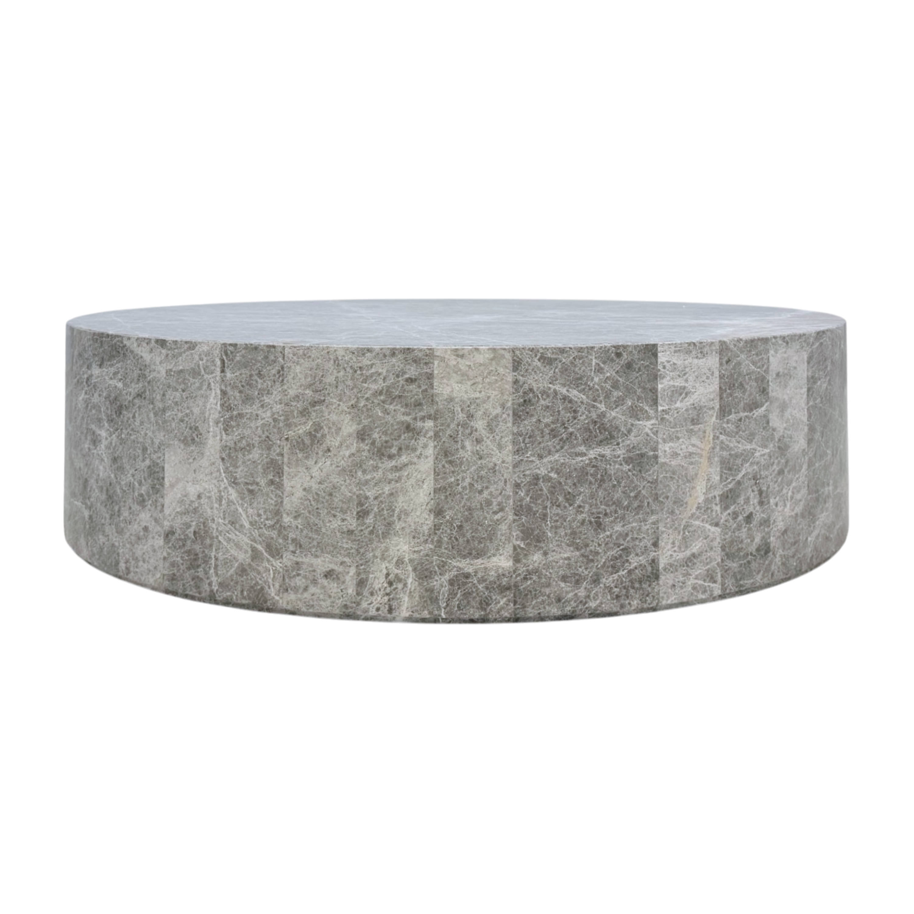 Ward Coffee Table in grey stone, featuring a low round drum silhouette with a smooth top and paneled sides highlighted by fine white veining.