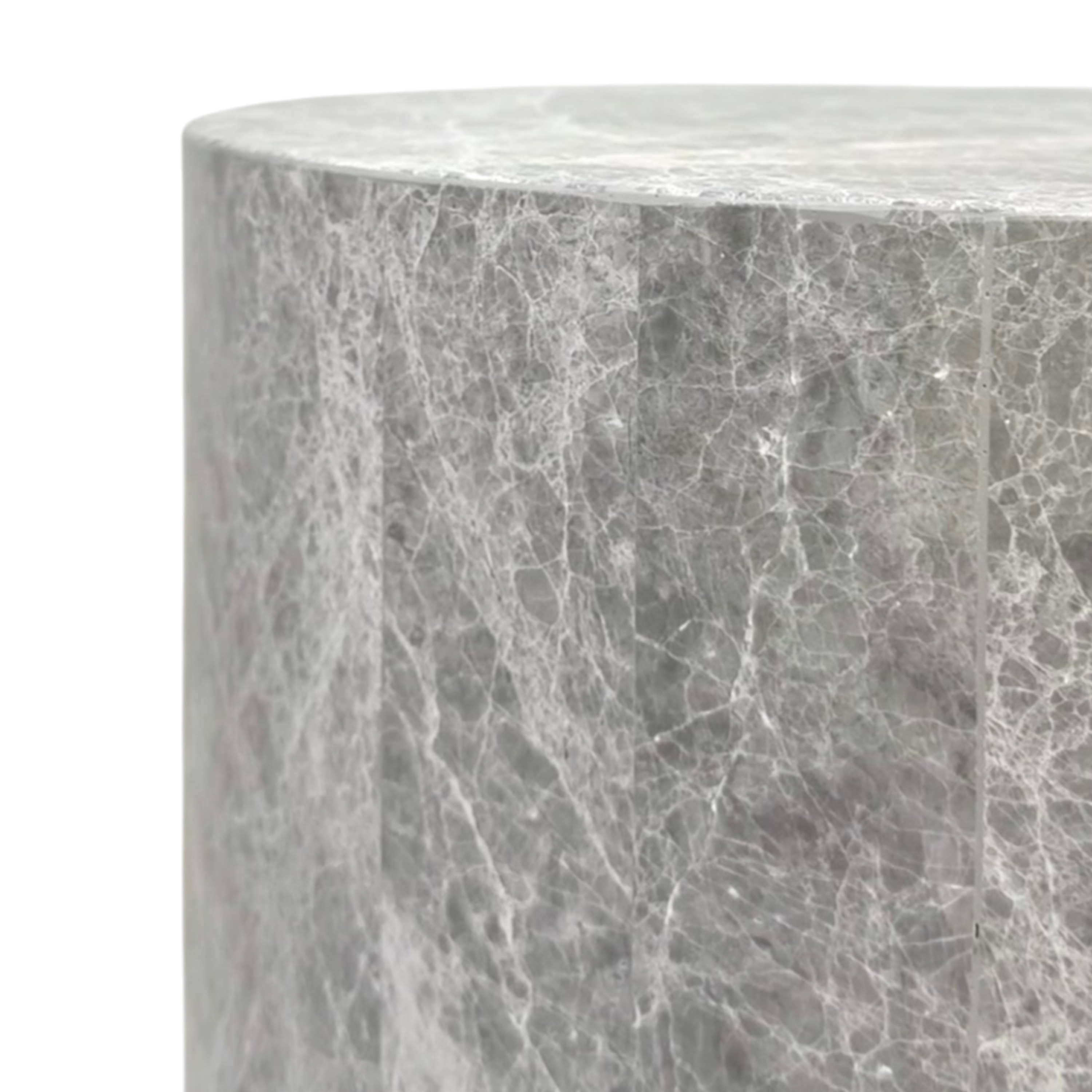 Close-up of the Ward Side Table, showing its rounded edge, cylindrical form, panel lines and intricate white veining across the grey stone surface.