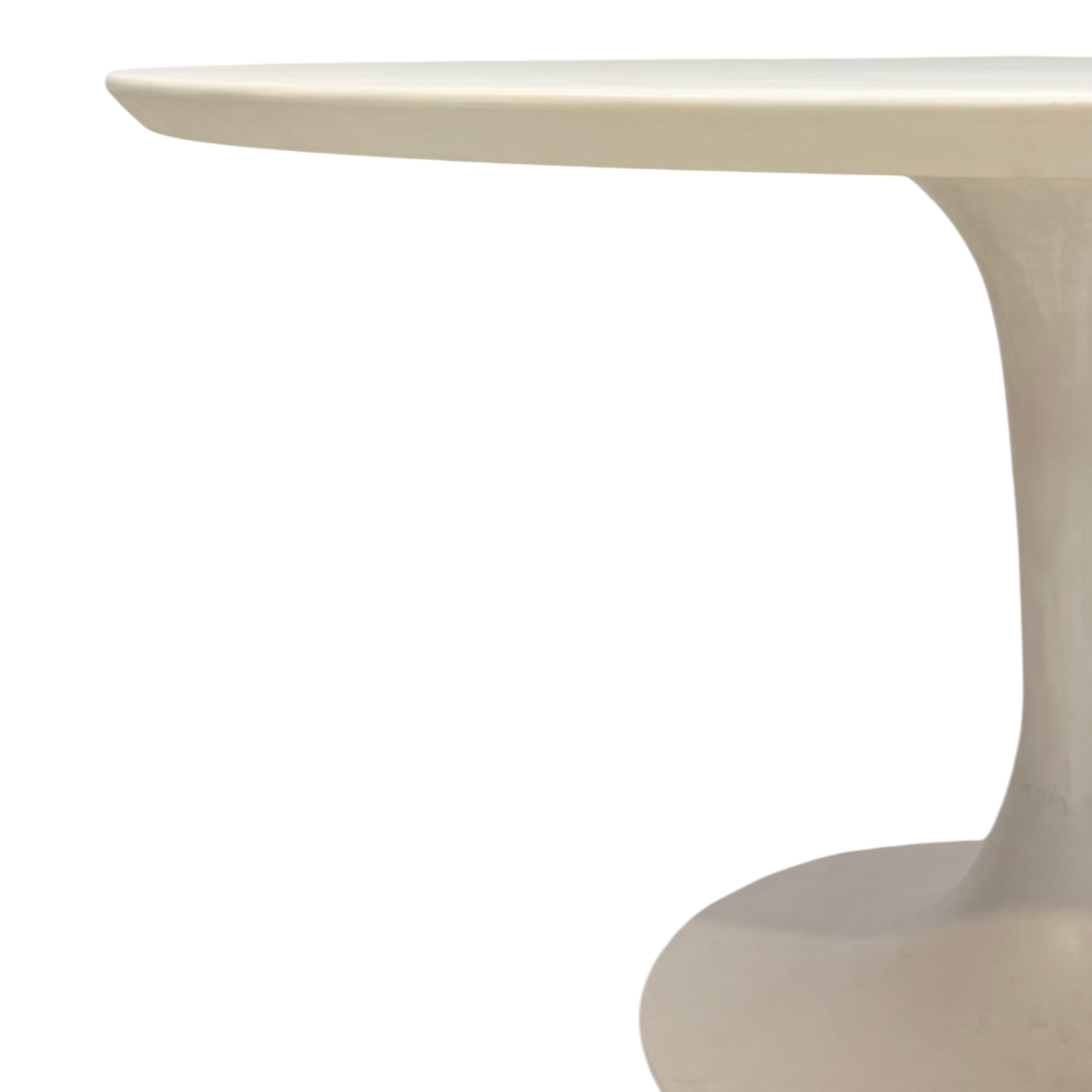 Close-up of a modern sculptural table with a smooth, curved cream-colored top and pedestal base on a white background.