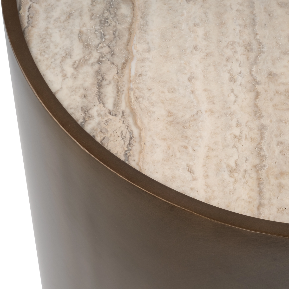 Close-up showing the rim of the Pedra Round Side Table in Aged Bronze, where the metal edge frames the cream travertine, with grey veining and fine natural pitting.