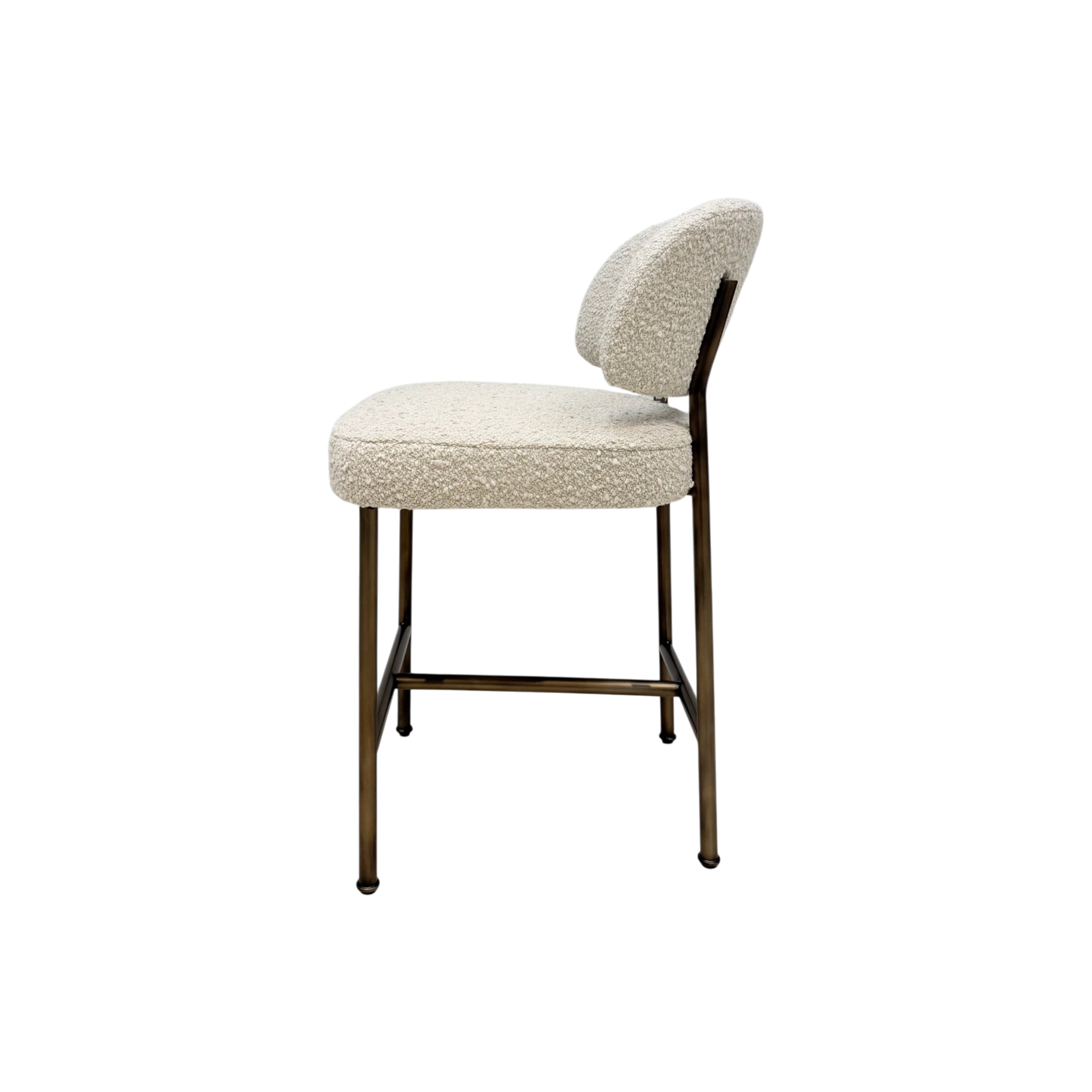 A modern bar stool featuring textured cream bouclé upholstery on the seat and curved backrest, supported by a slim bronze-finished metal frame.