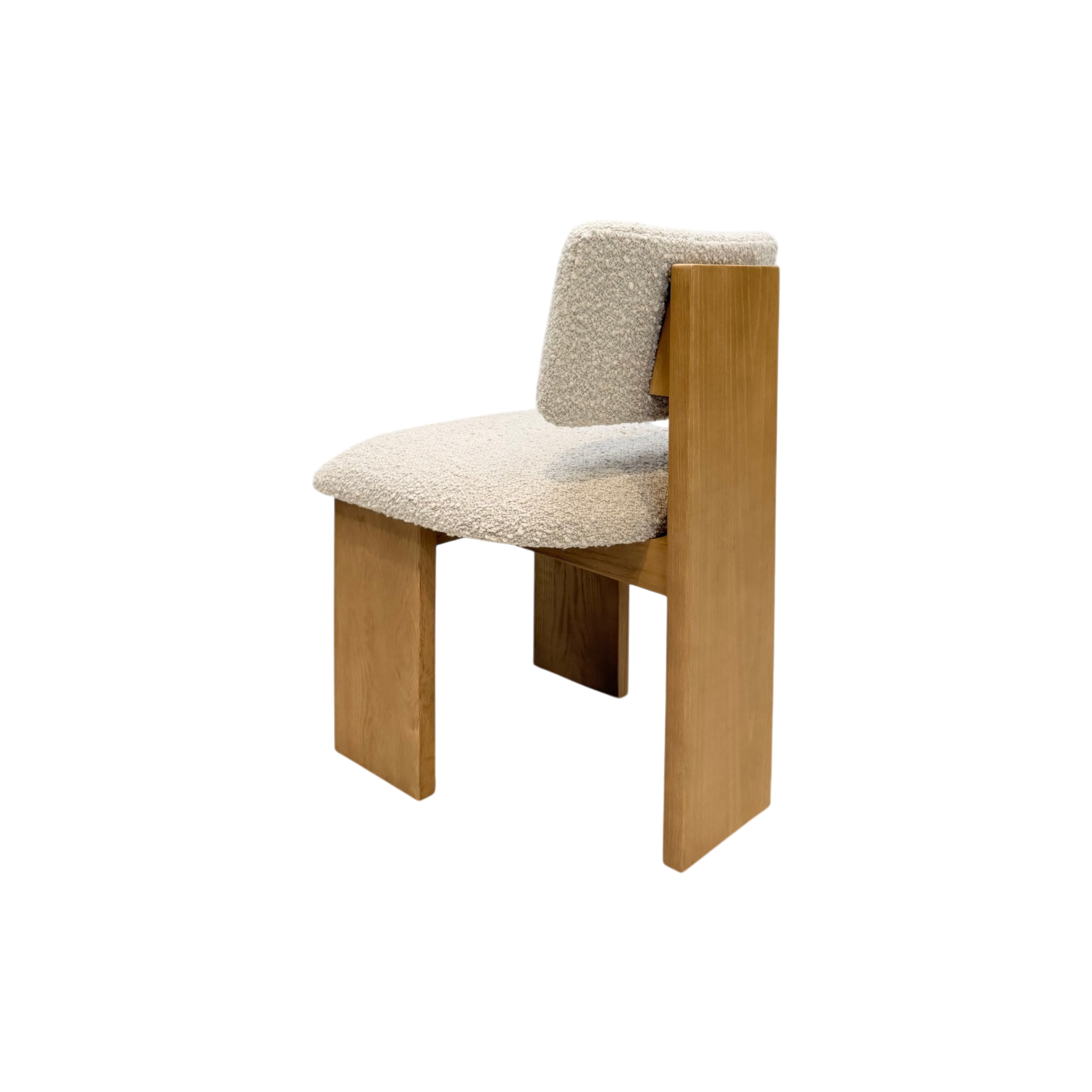 A modern wooden chair with a textured cream bouclé seat and backrest, shown against a plain white background.