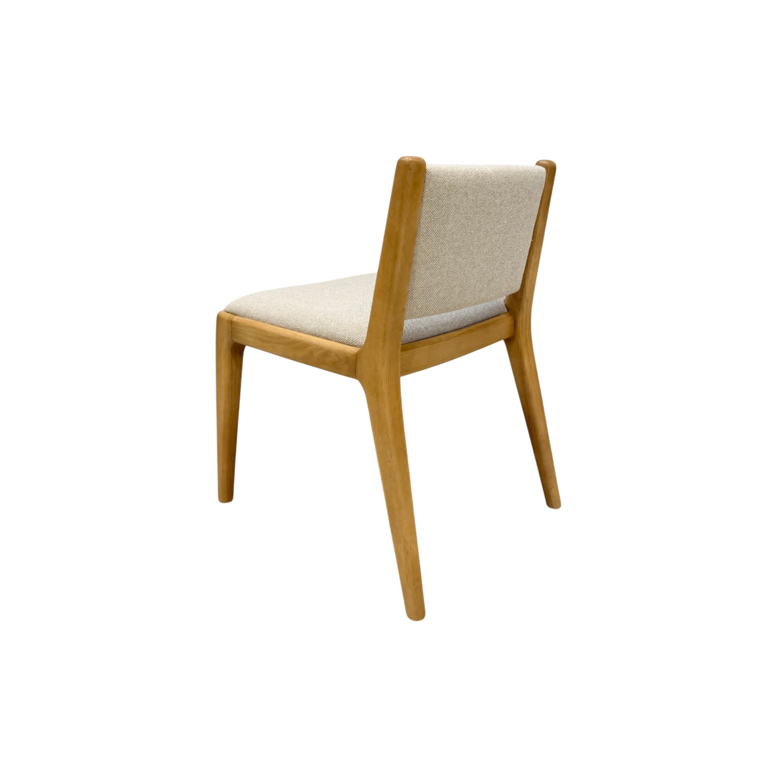 A modern wooden dining chair with a light beige upholstered seat and backrest, shown from a three-quarters angle on a solid white background.