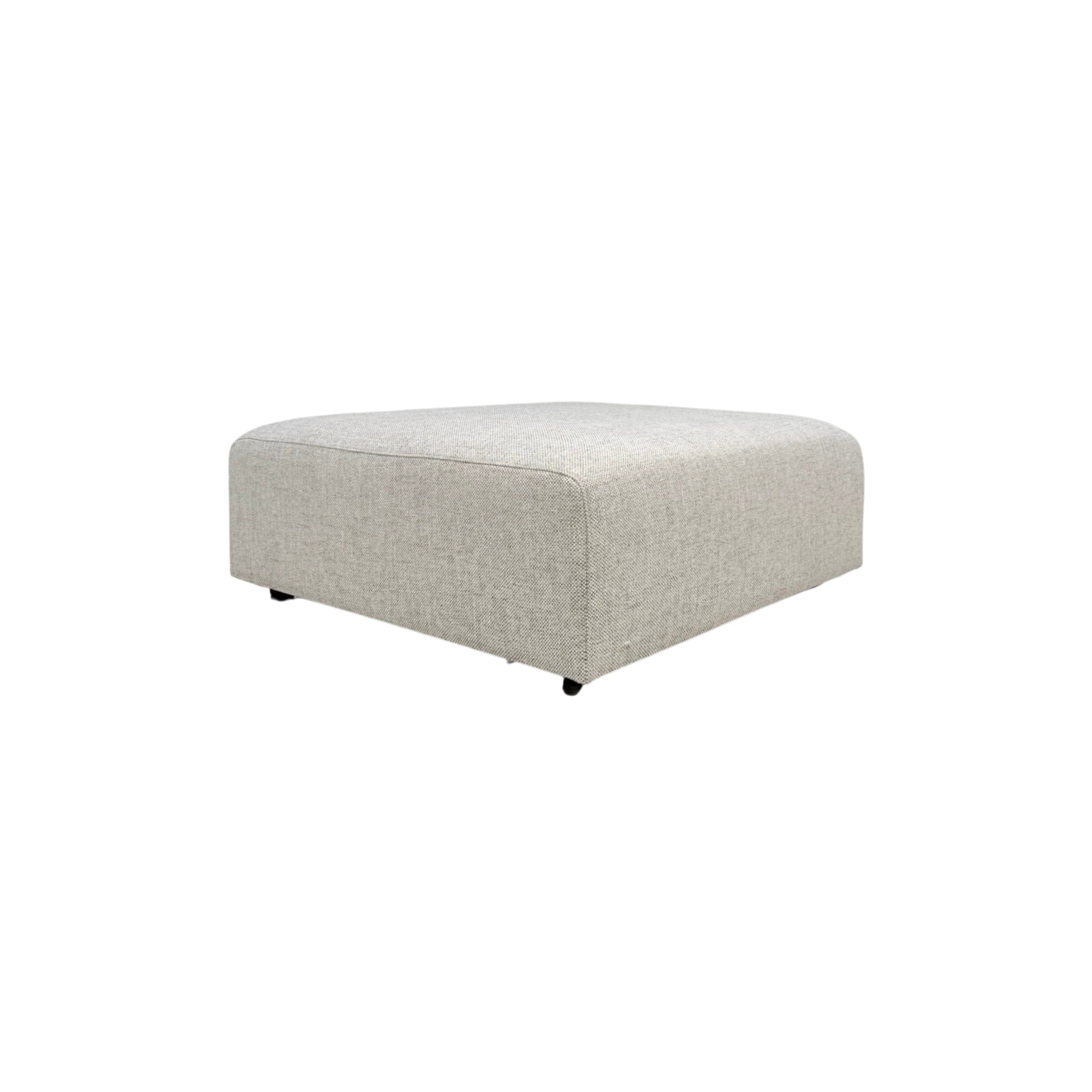 Vetro Bullnose Ottoman in light woven grey upholstery, three-quarter view showing the low, wide form and softly rounded edges.
