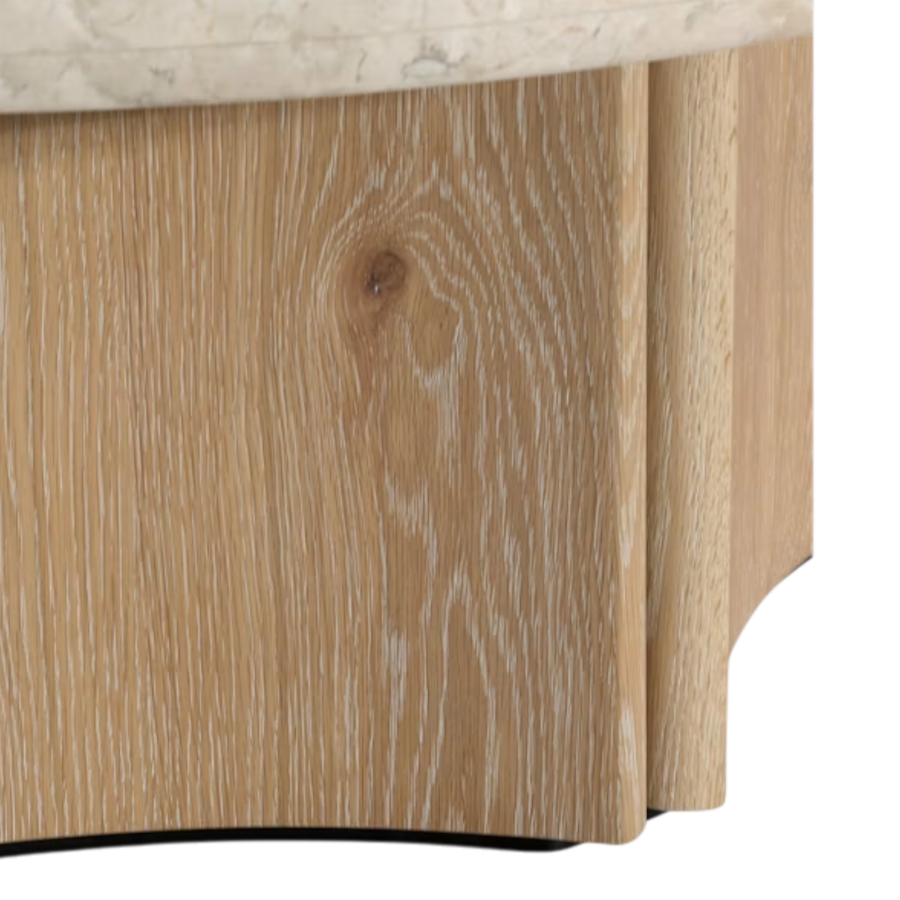 Close-up of the Aldridge Coffee Table base, showing the light-oak grain, softly curved panel edges and pale stone top above.