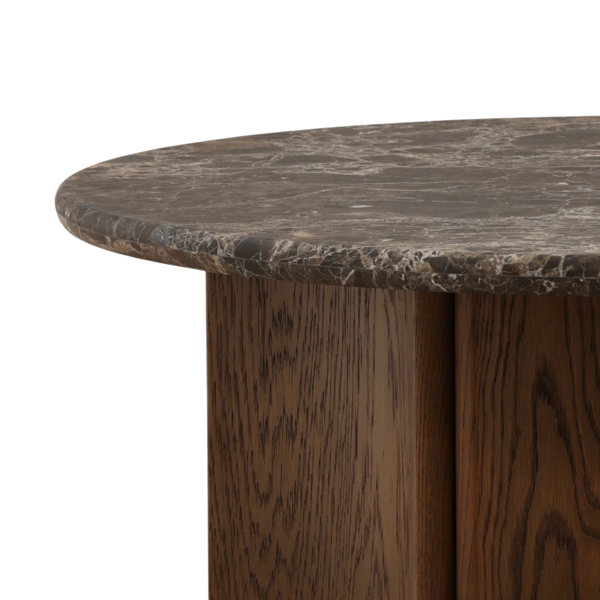 Detail view of the Aldridge Coffee Table showing the rounded dark marble edge above the richly grained wood base.