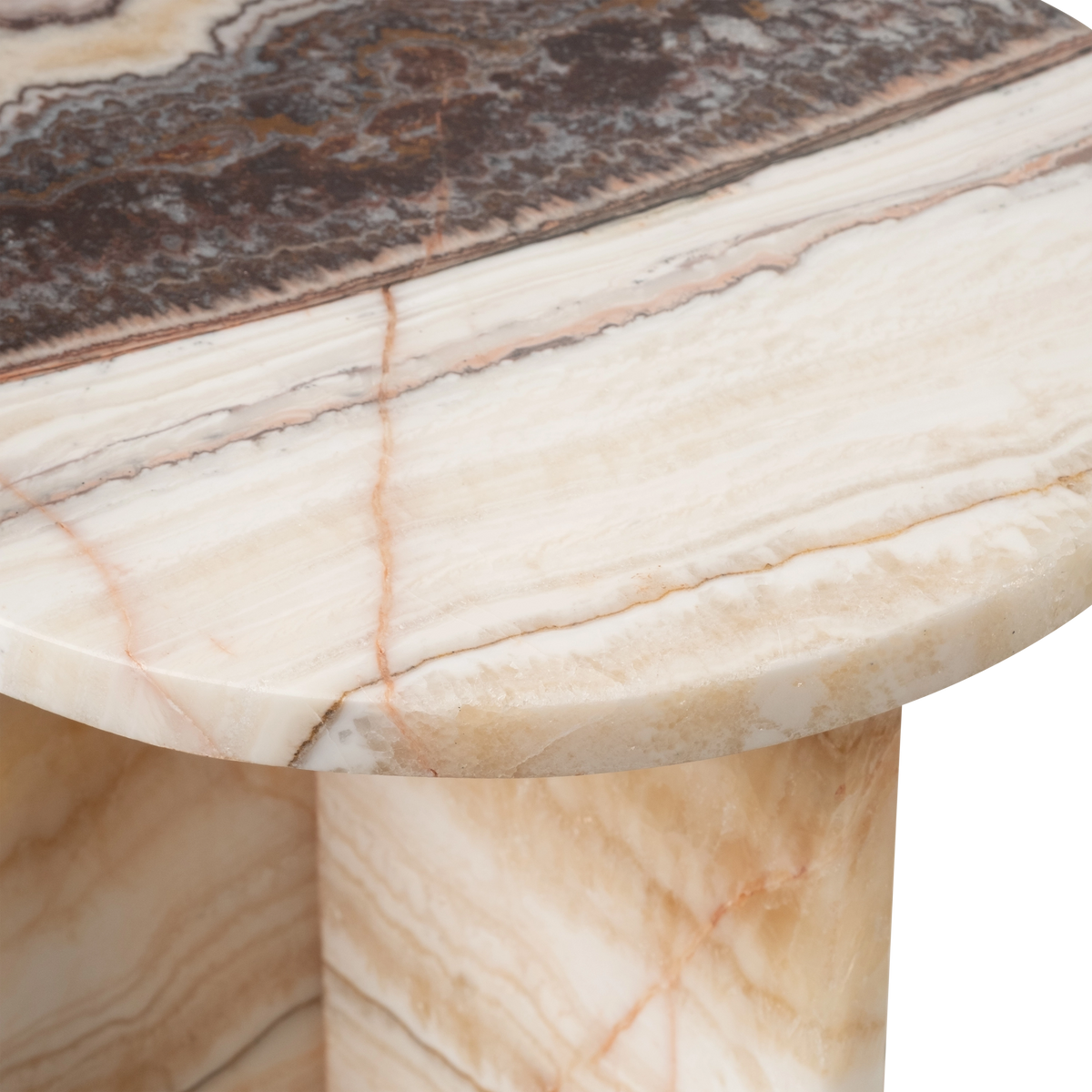 Close-up showing the cream and brown onyx top of the Onyx Side Table, with its thin polished edge, peach veining, and warm honey crystal along the rim.
