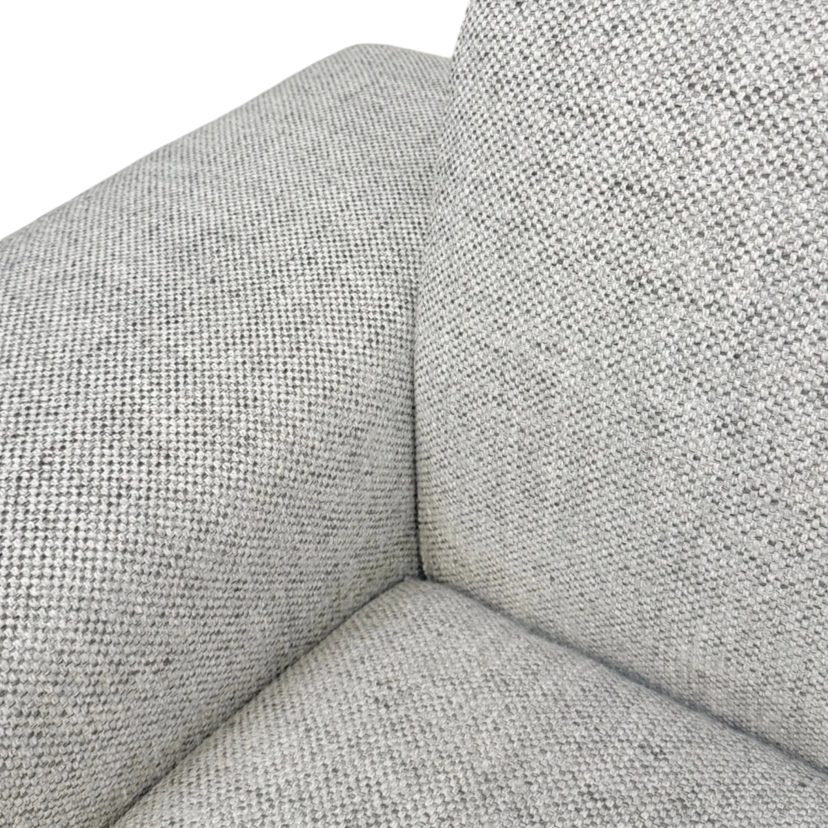 Vetro Bullnose Sectional close-up showing the heathered gray basketweave texture at the back-to-seat seam, with its subtle two-tone weave.