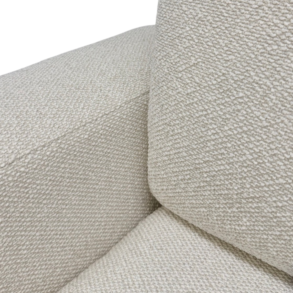 Tempo Modular Sectional fabric detail highlighting the textured ivory upholstery across the armrest and plush loose back cushion.